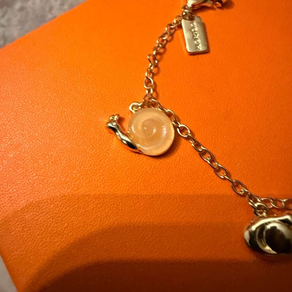 Coach Gold creature multi Charm Bracelet with Amber Heart & White Cat Charm - Picture 2 of 10
